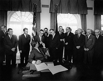 President Kennedy signs the Maternal and Child Health and Mental Retardation Planning Amendments Act, 1963. (Abbie Rowe. White House Photographs. John F. Kennedy Presidential Library and Museum, Boston)